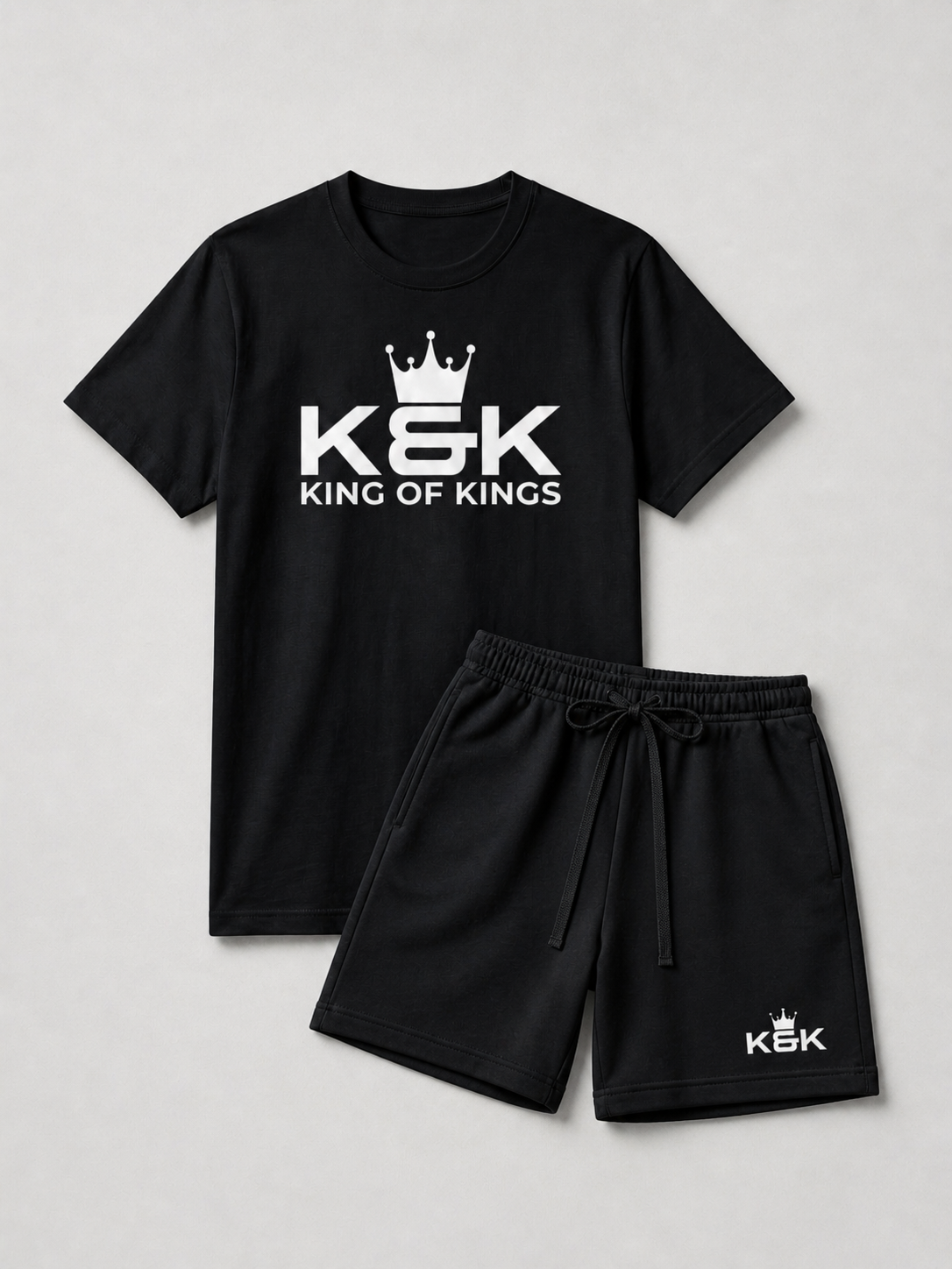 Black t-shirt and shorts set with 'K&K King of Kings' logo on a light gray background