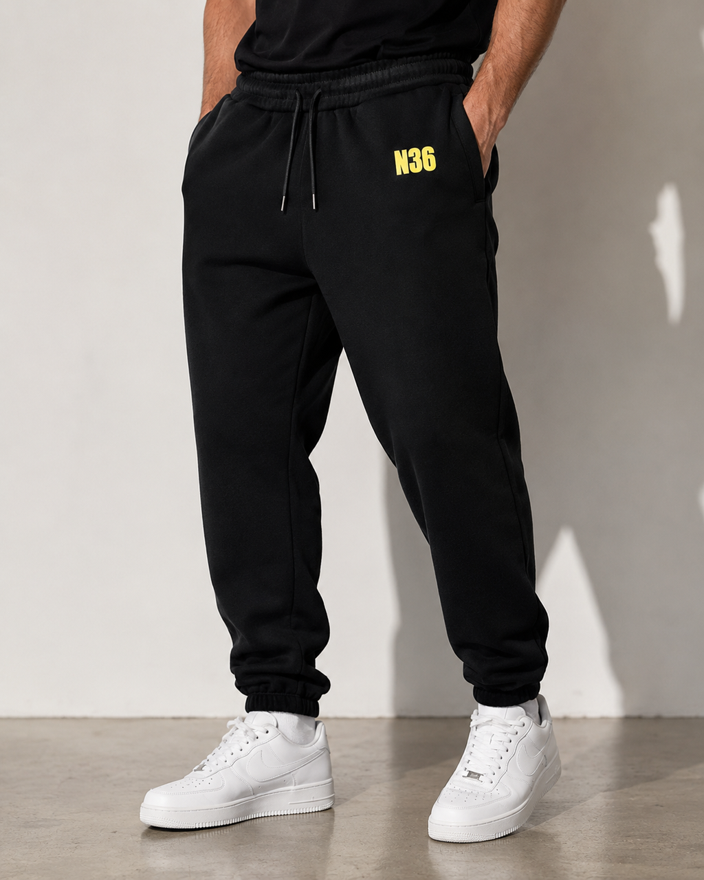N36 unisex black trackpants with yellow thigh logo, elastic waistband and drawstring