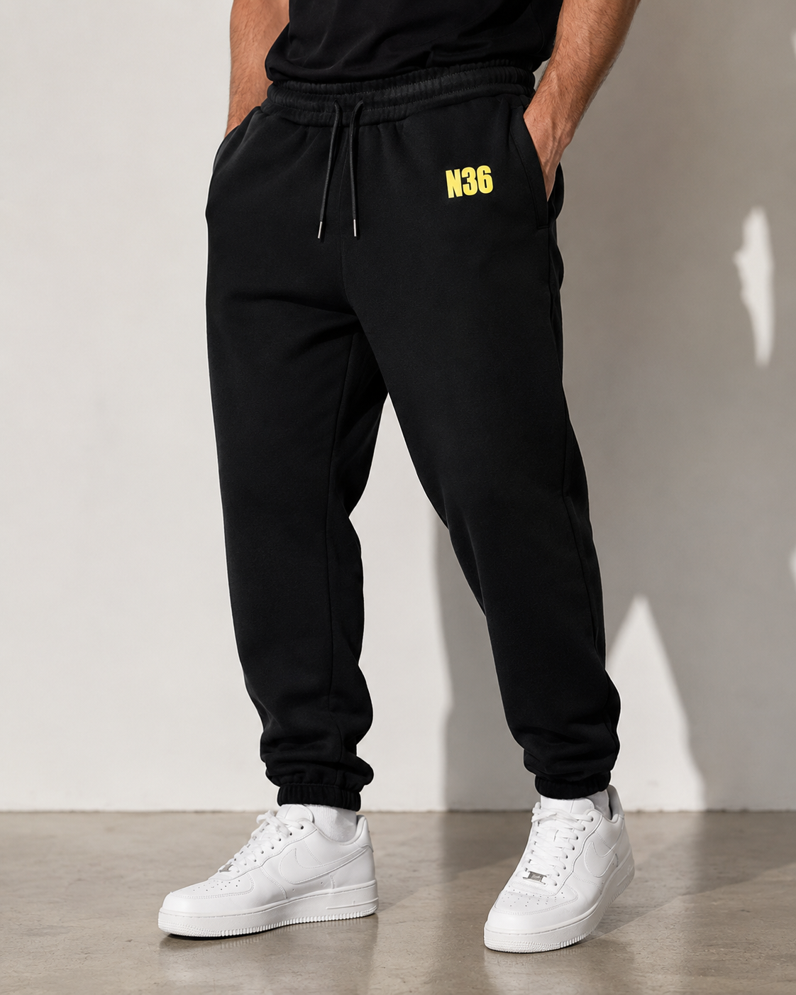 N36 unisex black trackpants with yellow thigh logo, elastic waistband and drawstring